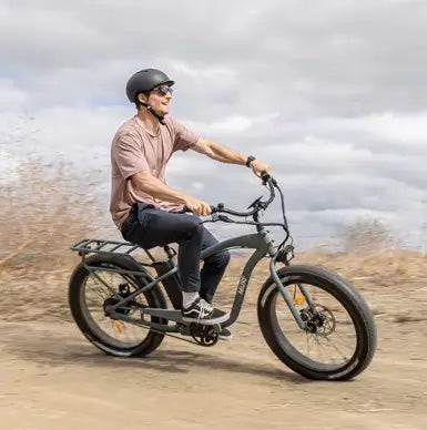 Man riding his Alpha Murf fat tyre electric bike on a dirt road in Australia.