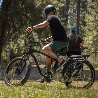 Man riding his Alpha Murf fat tyre electric bike on a dirt road in Australia.