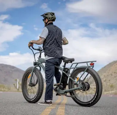 Man riding his Alpha Murf fat tyre electric bike on a road in Australia.