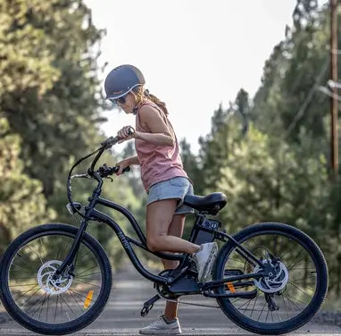 Woman on her cruiser e-bike on a bike path.