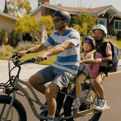 A father bringing his two daughters to school on his Alpha Murf Cargo electric bike.