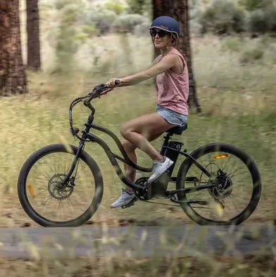 A woman riding her fat tyre electric cruiser bike.