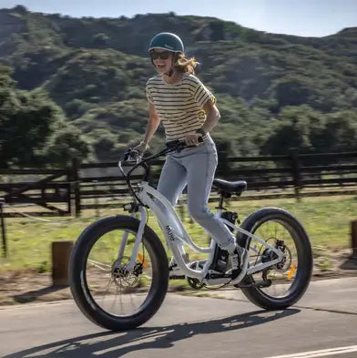 A woman at high speed on her fat tyre, step through electric bike from Murf Electric Bikes.